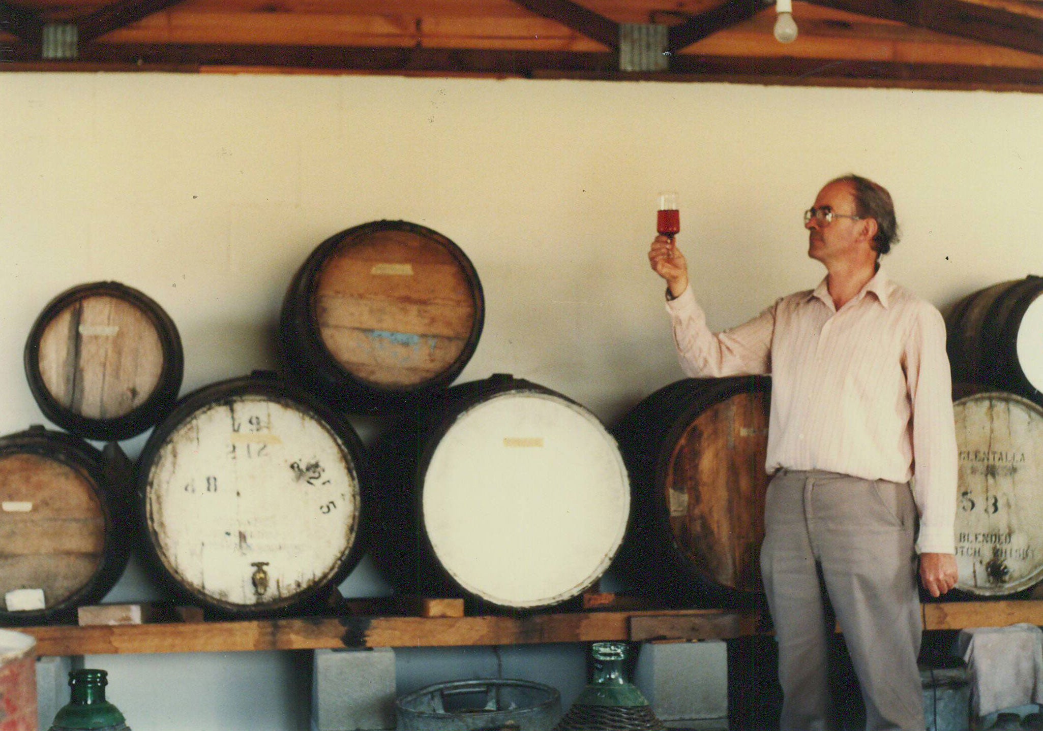 John Kirk holding a glass of wine