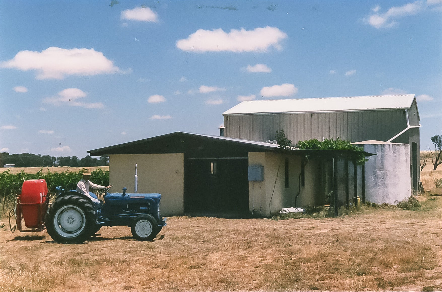 Tractor in front of old winery building